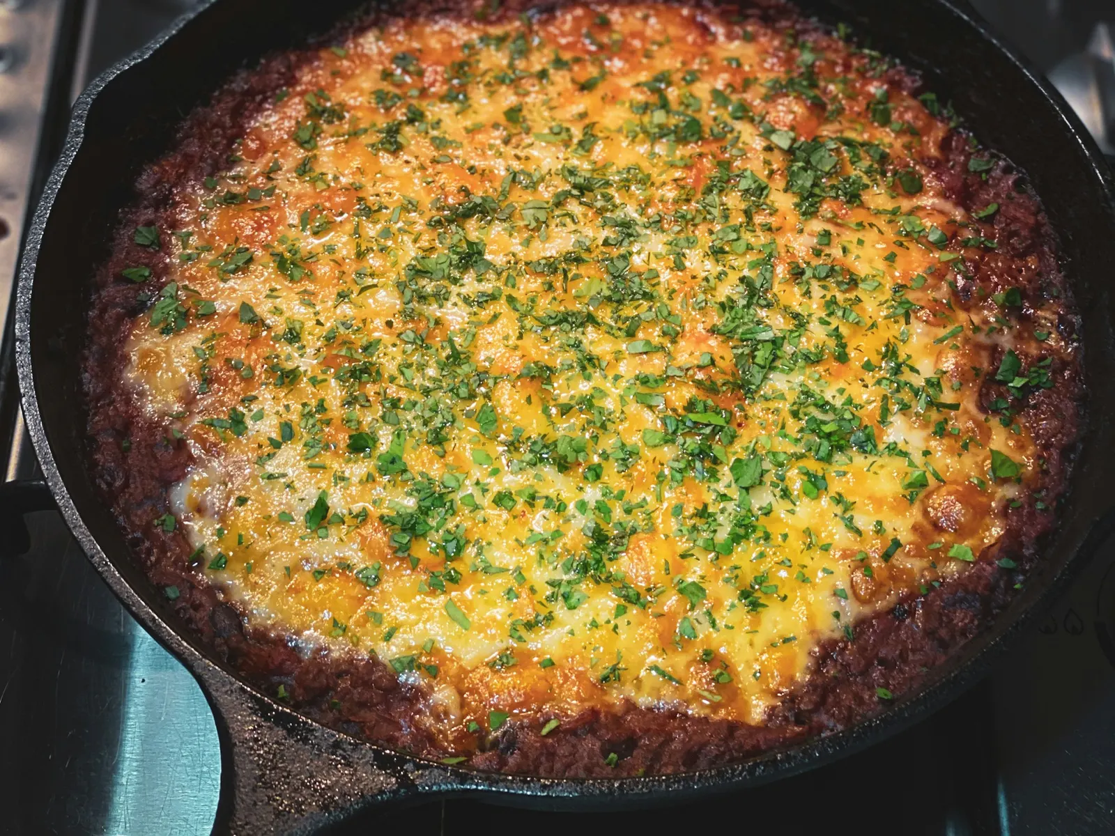 Taco-seasoned ground meat cooking in a black skillet