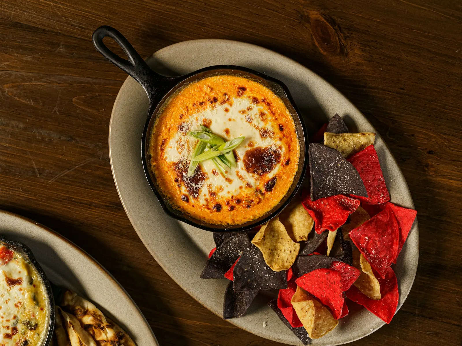 Healthy buffalo chicken dip in a skillet with tortilla chips