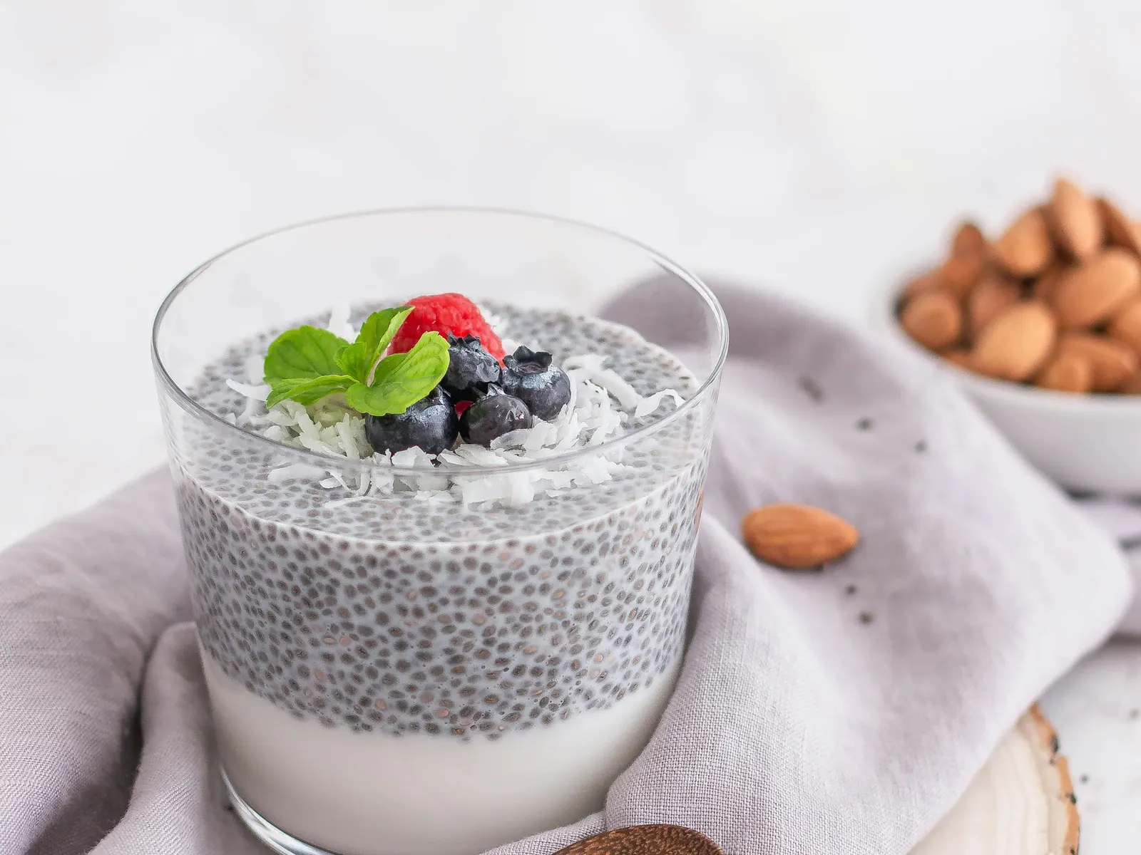 Glass of protein chia pudding topped with berries