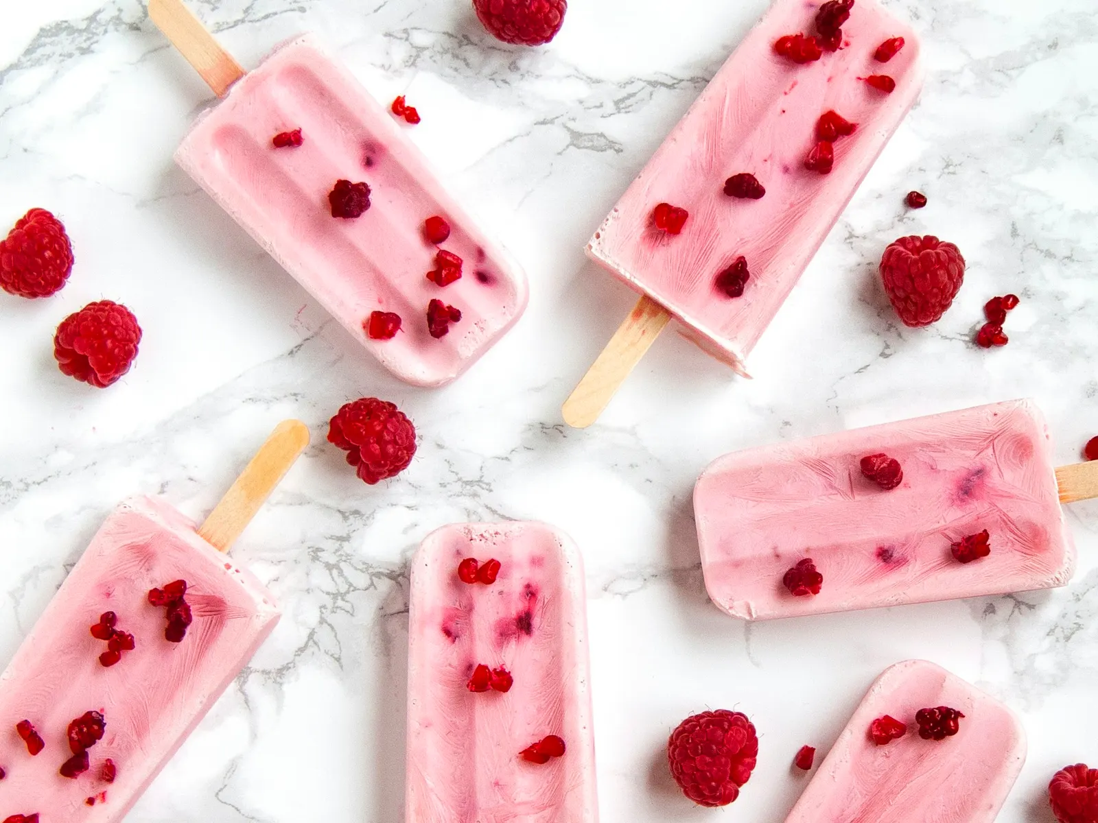 Berry yogurt protein popsicles with raspberries